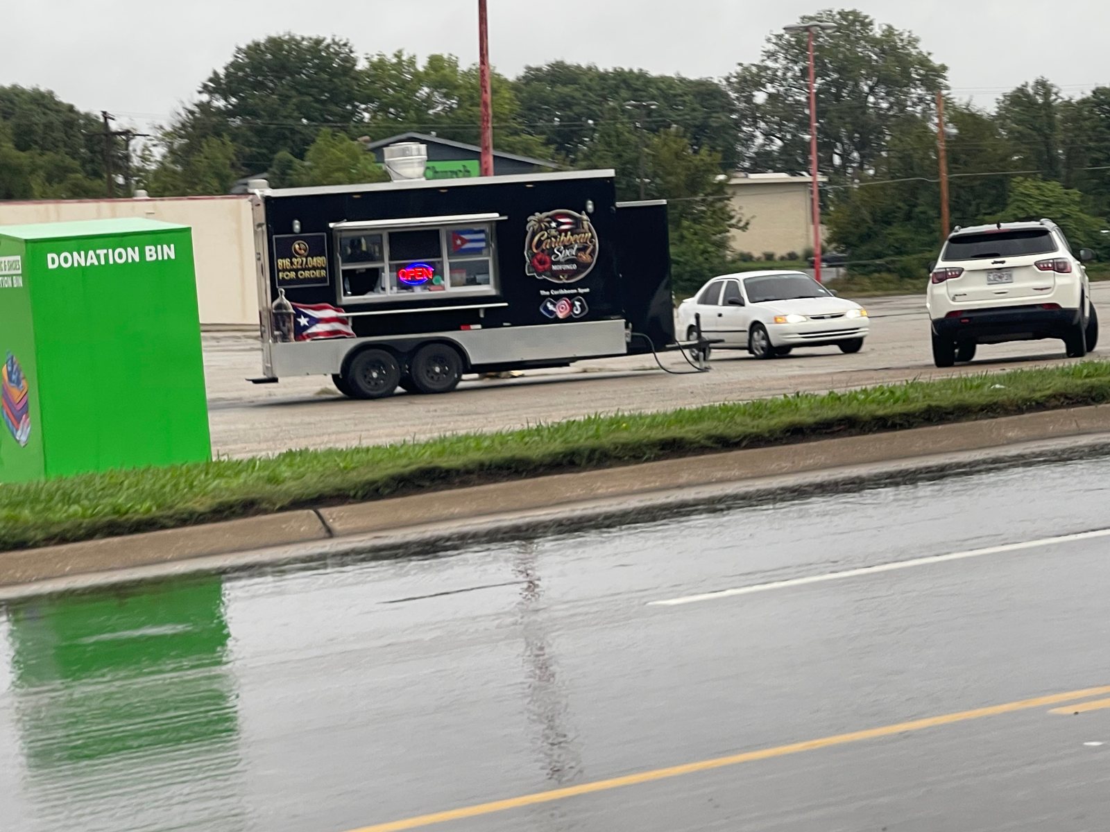 A Caribbean food truck whose ornate lettering is difficult to read quickly from the road